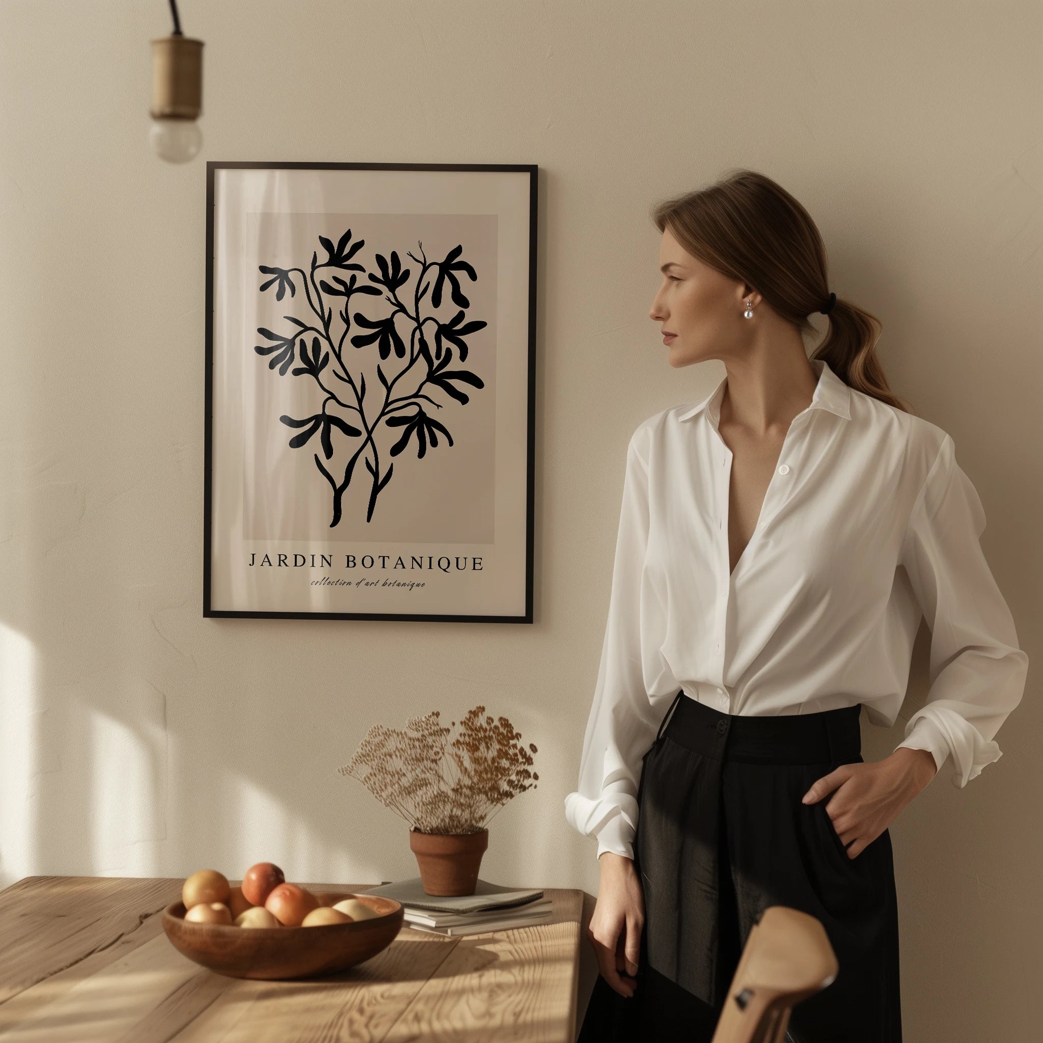 Black botanical branch poster styled in modern living room with neutral beige decor