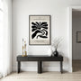 Abstract black flowers poster displayed in gallery wall with monochrome art