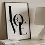 LOVE poster displayed in a soft romantic gallery wall arrangement